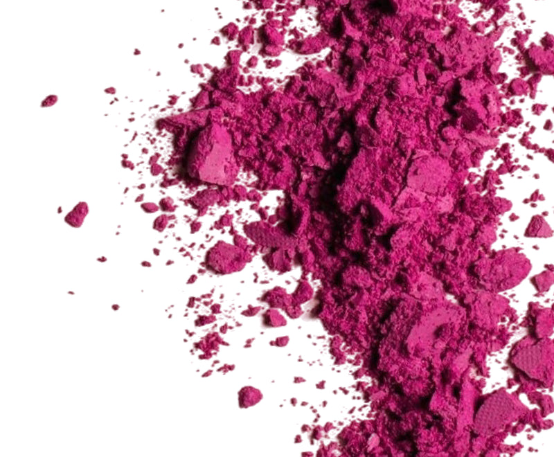 Close-up of magenta vitamin B12 powder scattered on a white background