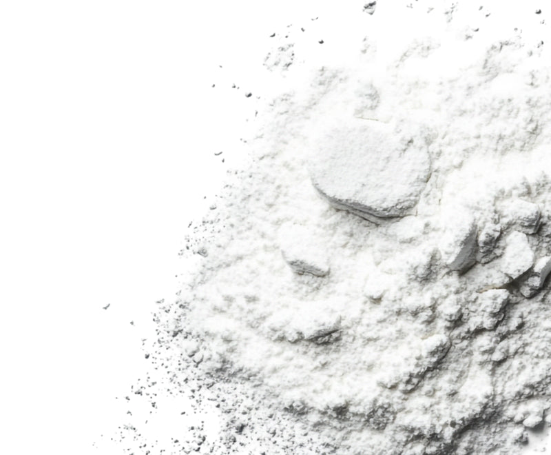Close-up of Vitamin B6 powder showing fine white powder texture on a white background